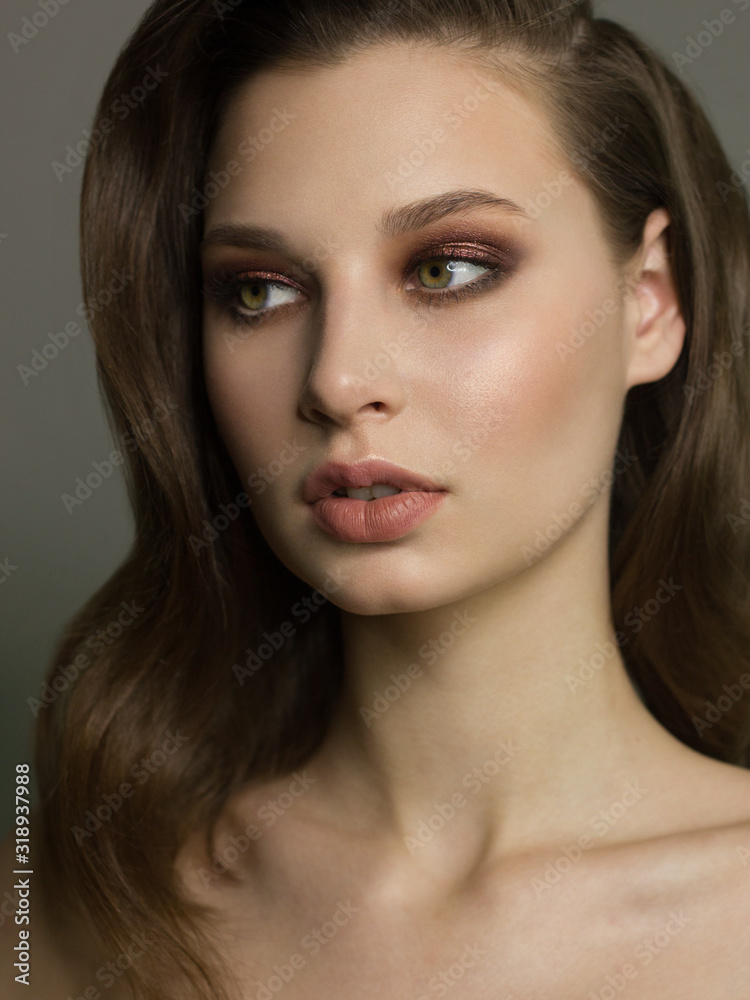 Close-up portrait of the cleanliness face of a beautiful woman with dark black smoky eyes makeup, natural full lips. Sexy model with clean shiny skin, clean face, long curly hair. glamorous image Close-up portrait of the cleanliness face of a beautiful woman with dark black smoky eyes makeup, natural full lips. Sexy model with clean shiny skin, clean face, long curly hair. glamorous image
