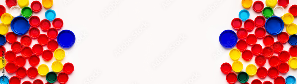 Colored plastic bottle's covers on white background, top view Colored plastic bottle's covers on white background, top view