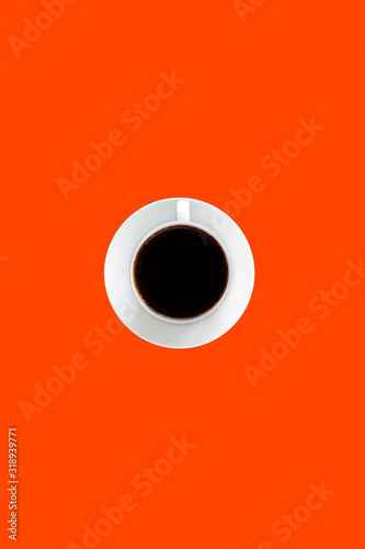 Black coffee espresso in white cup and saucer, bright red color background with empty space for text, unhealthy food concept 
