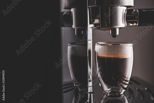 Freshly prepared portion of espresso in a glass glass, coffee machine