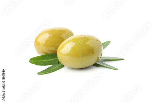 Tasty green olives and leaves isolated on white background  close up