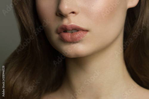 Sexual full lips. Natural gloss of lips and woman's skin. The mouth is closed. Increase in lips, cosmetology. Natural lips. Great summer mood with open eyes. fashion jewelry. Pink lip gloss