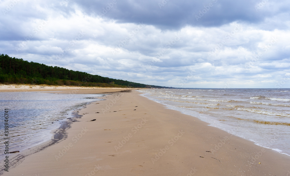 Clouds on a cloudy sky over the sandy beach of the Baltic Sea in Jurmala Clouds on a cloudy sky over the sandy beach of the Baltic Sea in Jurmala
