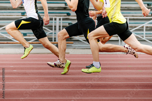 Fototapeta legs men athletes runners running race sprint in athletics