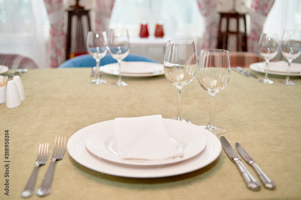 Table setting with empty white plate, napkin and cutlery on table, copy space. Menu mockup, place setting at wedding reception. Table served for wedding banquet in restauran Table setting with empty white plate, napkin and cutlery on table, copy space. Menu mockup, place setting at wedding reception. Table served for wedding banquet in restauran