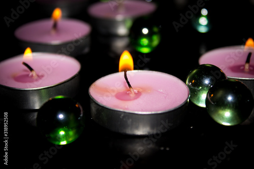 Lighted decorative candles on a black background
