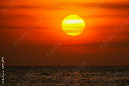 Sea buoy in the ocean on a sunset background © nelasova
