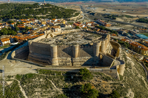 Aerial view of Chinchilla de Montearagon castle with ruined excavated inner building remains surrounded by an outer wall with semi circular towers photo