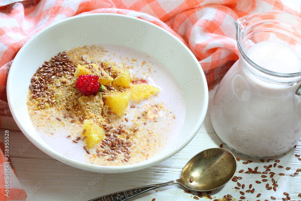 Yogurt with flax seeds, grapefruit, raspberries and orange on a white background Yogurt with flax seeds, grapefruit, raspberries and orange on a white background
