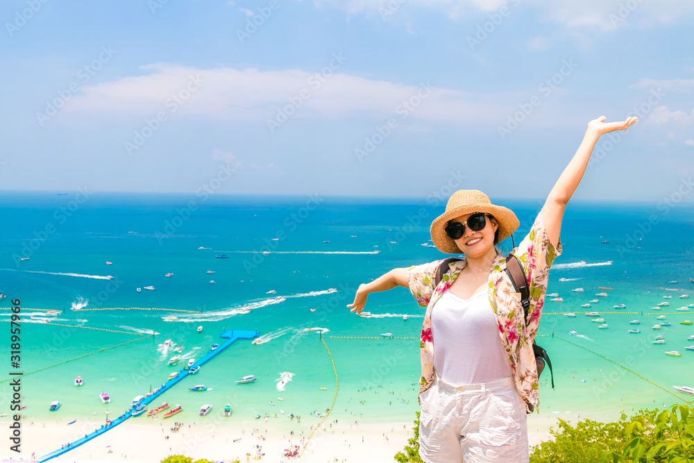 woman traveler with backpack and hat look at the Sea beach and background from “Koh larn“ in pattaya ,Thailand. Traveling Thailand. woman traveler with backpack and hat look at the Sea beach and background from “Koh larn“ in pattaya ,Thailand. Traveling Thailand.
