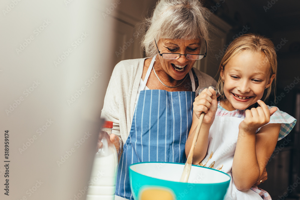 Granny and kid having fun in kitchen - obrazy, fototapety, plakaty 