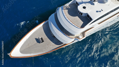 Aerial drone photo of luxury mega yacht docked in Mediterranean destination with deep blue wavy sea