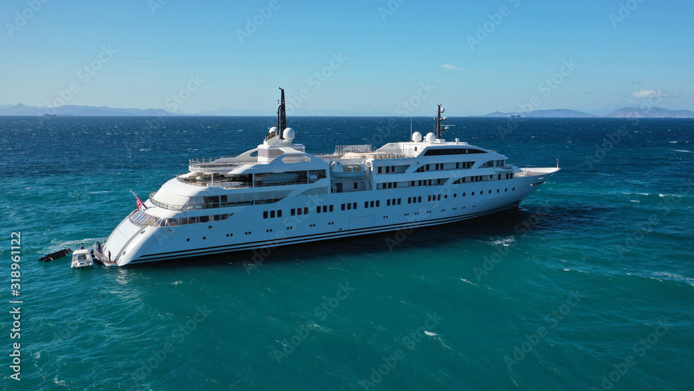 Aerial drone photo of luxury mega yacht docked in Mediterranean destination with deep blue wavy sea