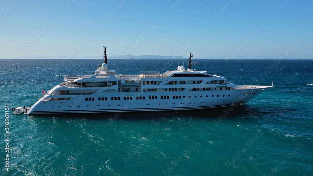Aerial drone top down photo of luxury yacht docked in Mediterranean destination port with deep blue sea