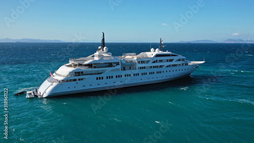 Aerial drone photo of luxury mega yacht docked in Mediterranean destination with deep blue wavy sea © aerial-drone