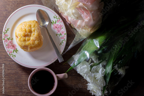 bread and coffee beark time with flower on table photo