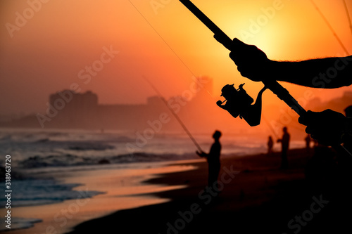 a man fishing at sunset