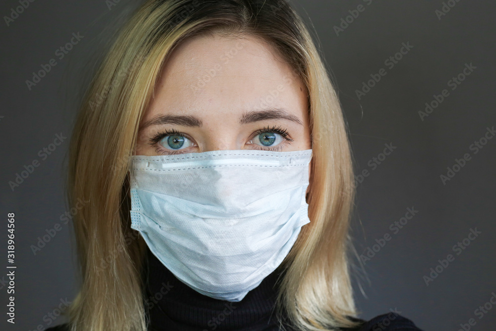 Sick woman wear a medical face mask against virus and protecting herself. Self protection. Dislike sign. Sick woman wear a medical face mask against virus and protecting herself. Self protection. Dislike sign.