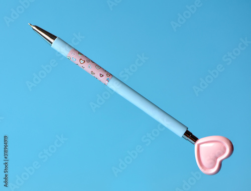 Valentines pen with heart on blue background