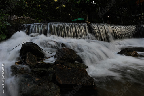 Waterfall/stream in a deep rain forest. © tuahlensa