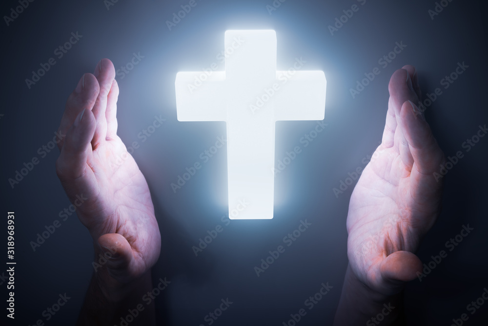 Man hands around shining light from glowing crucifix. Religion concept. Man hands around shining light from glowing crucifix. Religion concept.