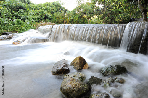 Waterfall/stream in a deep rain forest. © tuahlensa