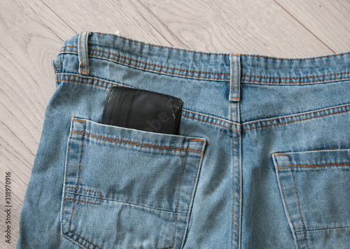 Brown wallet in the blue jeans pocket