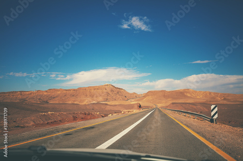 Driving a car on mountain Israel road. Desert landscape. Empty road. View from the car of the mountain landscape on a sunny day. Israel