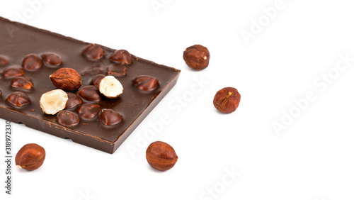 Chocolate with hazelnuts on white background.