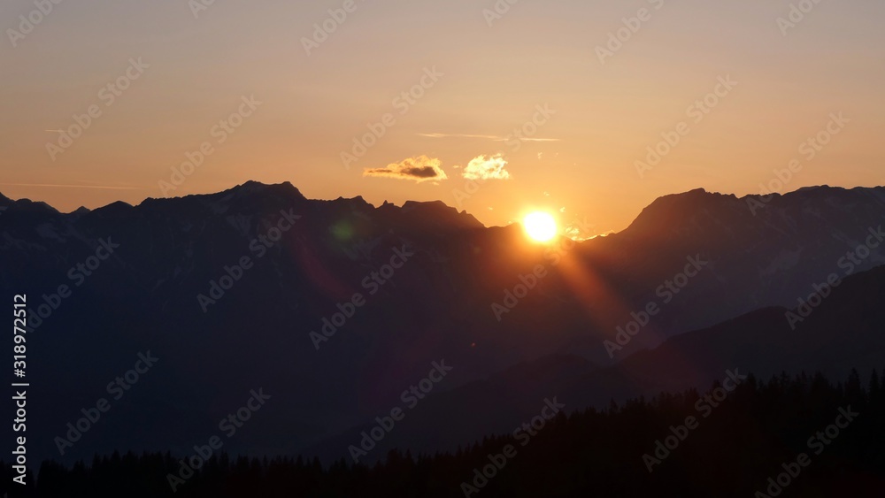 Obraz premium orange sky in the morning over the austrian alps