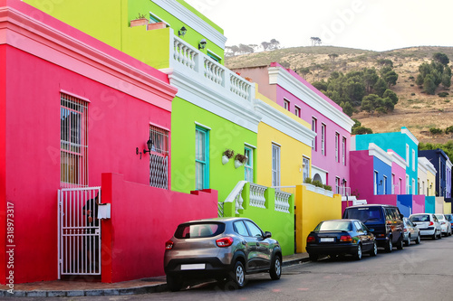Bright colorful buildings on the street in the historical Bo-Kaap or Malay Quarter district of Cape Town, South Africa. Traveling to exotic destinations.