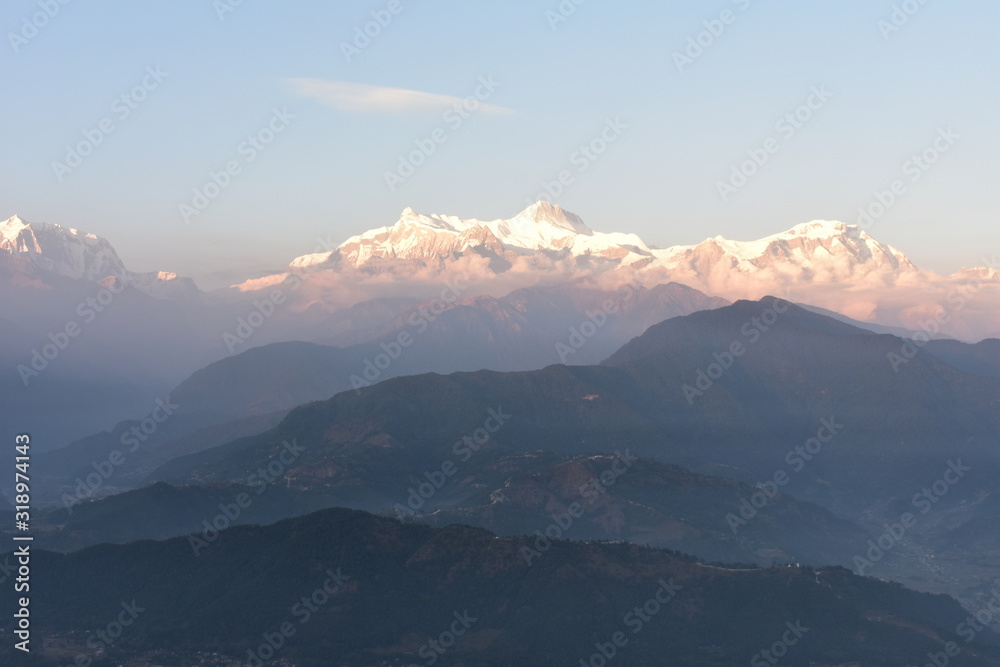 beautiful  panorama sunset in the  snow mountains and misty  mountains range