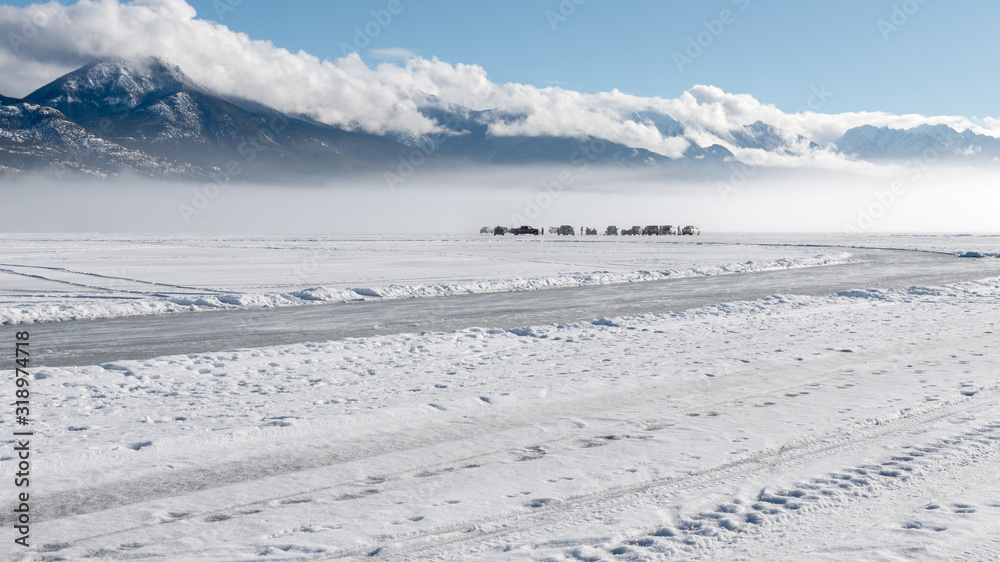 Ice fishing in the fog on Lake Windermere at Invermere, British Columbia, Canada