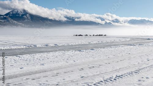 Ice fishing in the fog on Lake Windermere at Invermere, British Columbia, Canada