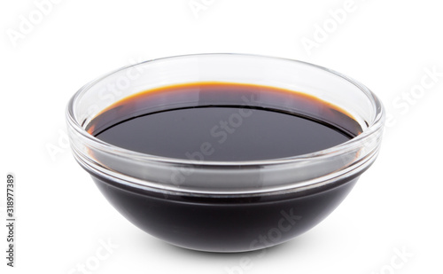 Soy sauce in transparent glass bowl isolated on white background