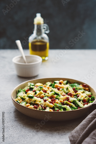 Quinoa salad with chickpeas, cucumber, avocado, parsley and pomegranate seeds