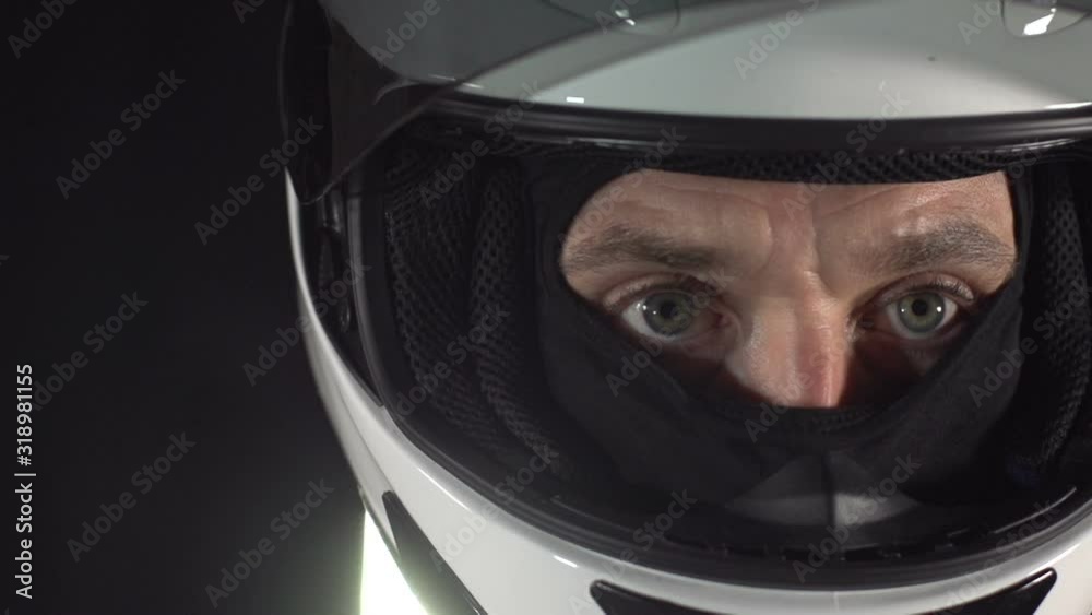 Motor Racing Driver wearing Helmet. Close up of the visor and eyes. Grand Prix man. Motorsports. Super slow motion Motor Racing Driver wearing Helmet. Close up of the visor and eyes. Grand Prix man. Motorsports. Super slow motion