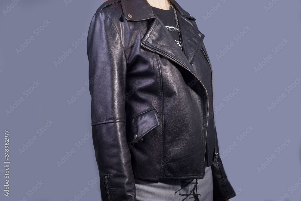 portrait of a girl in a high-quality leather jacket. Rock and roll style in women. Promotional photo of a leather jacket portrait of a girl in a high-quality leather jacket. Rock and roll style in women. Promotional photo of a leather jacket