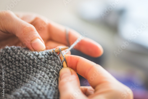 Knitting at home: Close up of wool, thread and female fingers