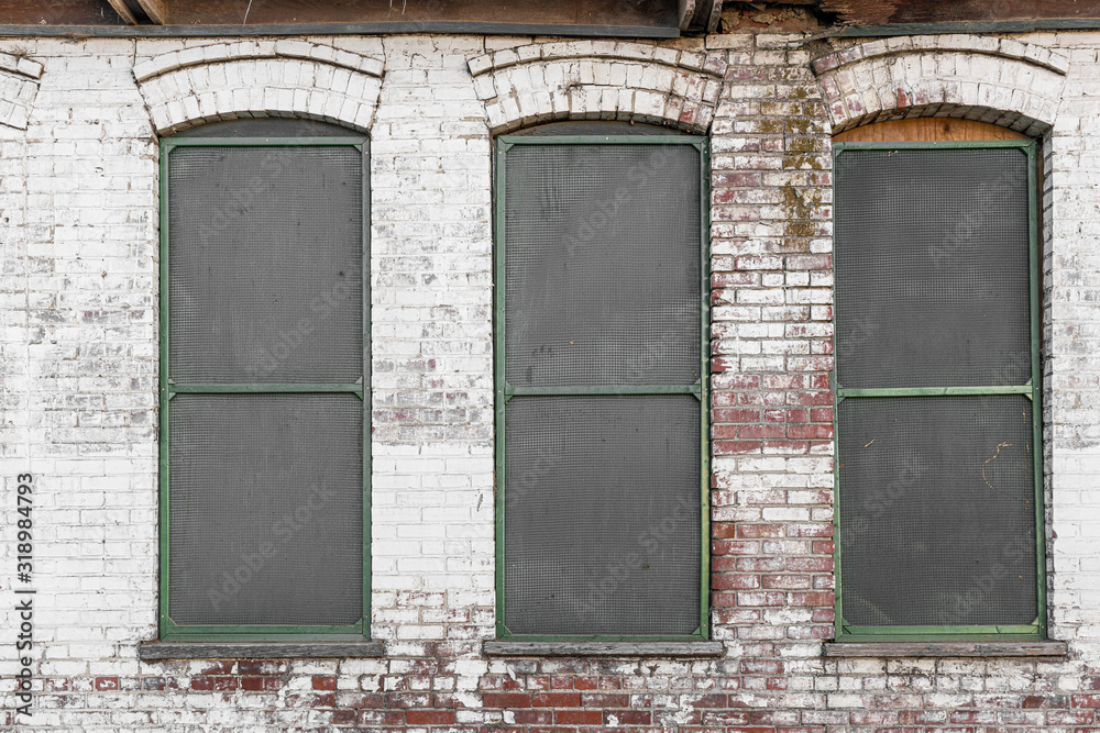 Three windows on an old abandoned industrial building