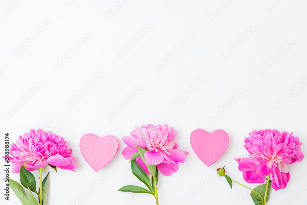 Flat lay valentines day border with pink peonies and gift box on a white  background