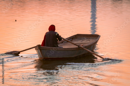 Man rowing the boat at the lake in Wankaner, Gujarat, India