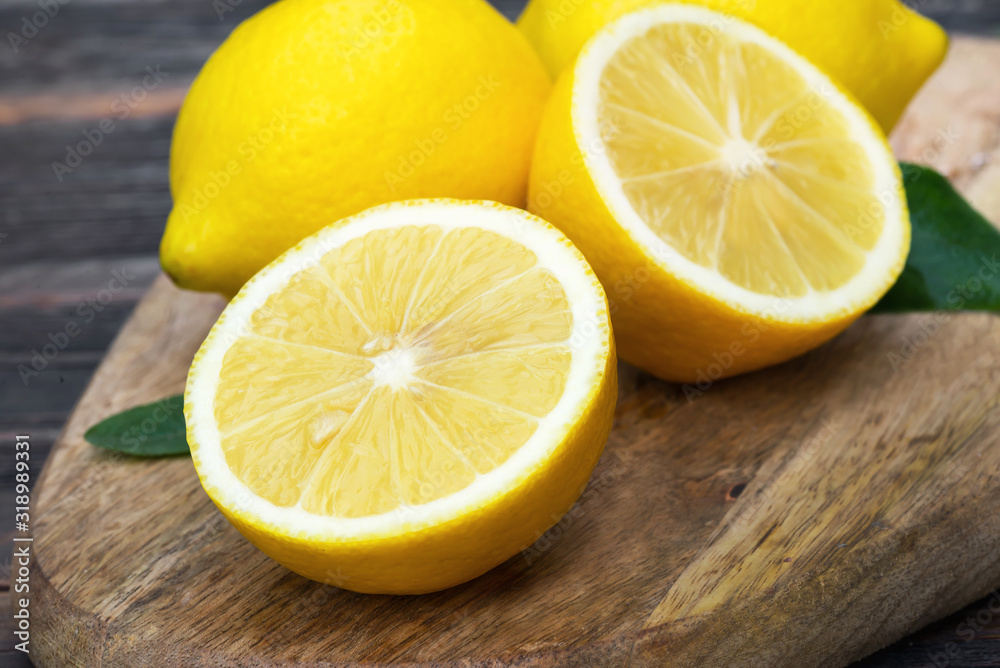 ripe sliced lemon fruits on wooden board ripe sliced lemon fruits on wooden board