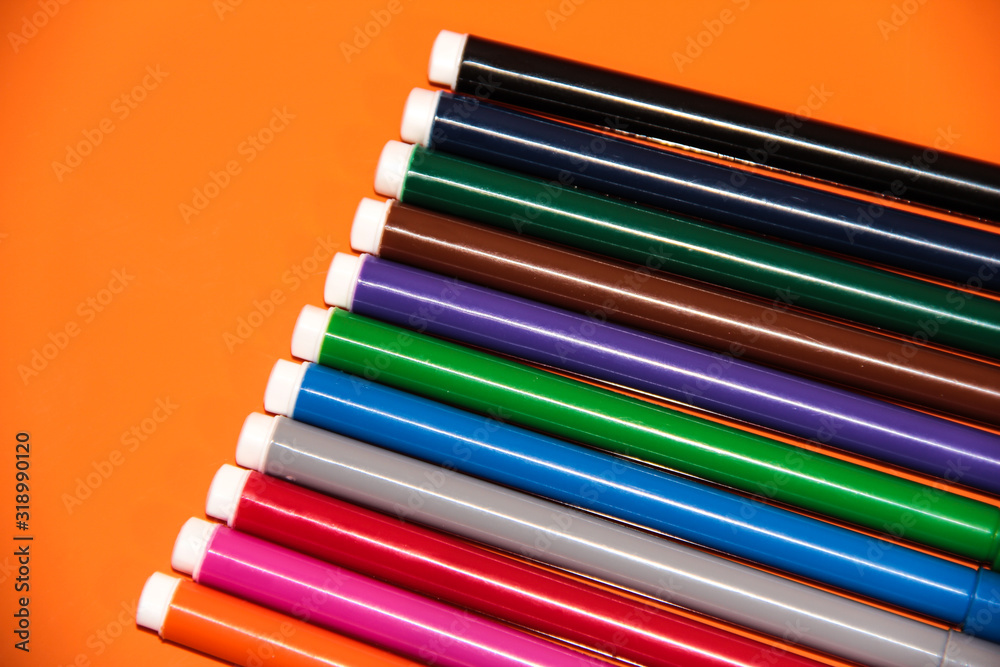 Fototapeta premium Markers in the right corner on an orange background.