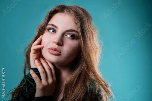 Portrait of a beautiful woman isolated on blue background with copy space