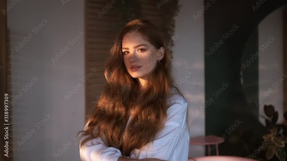 Pretty Red-Haired Girl With Long Hair In White Shirt Stands In The Bathroom. Pretty Red-Haired Girl With Long Hair In White Shirt Stands In The Bathroom.
