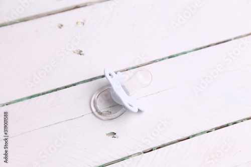 white pacifier in color background © robcartorres