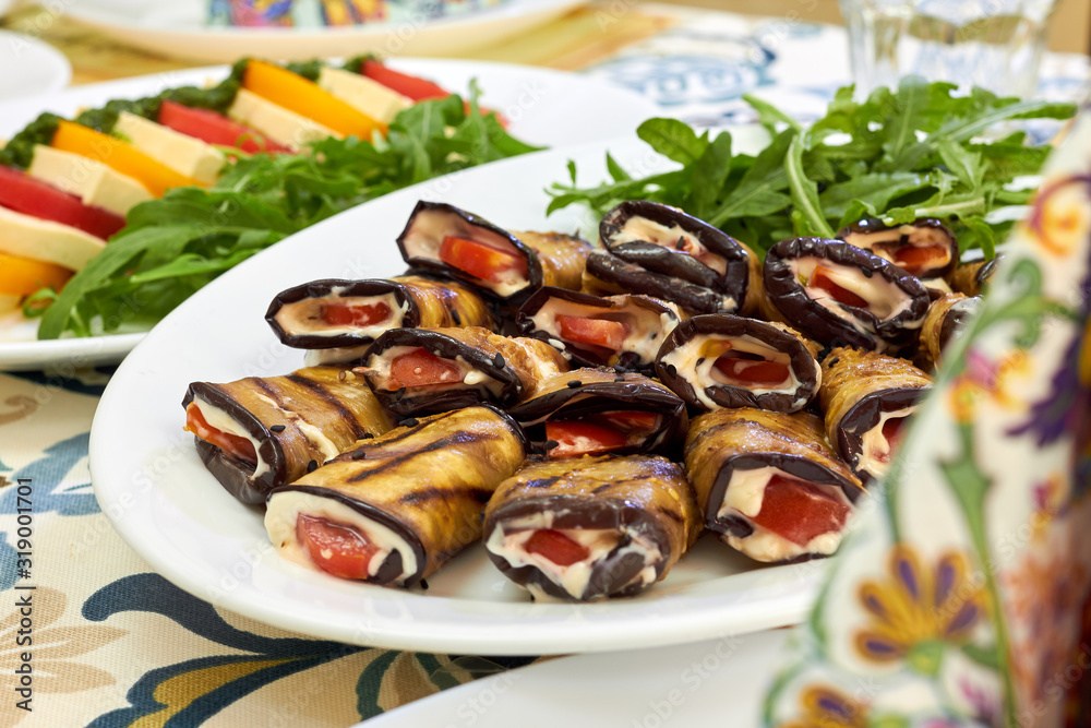 Rolls of fried eggplant with mayonnaise garlic sauce and tomato, close-up Rolls of fried eggplant with mayonnaise garlic sauce and tomato, close-up