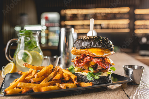 Black Burger with potato fries photo