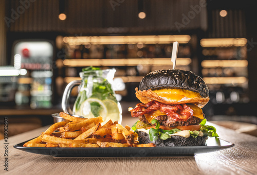 Black Burger with potato fries photo